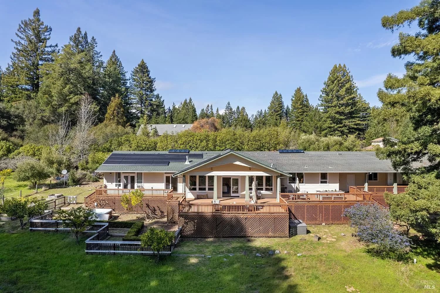 Aerial view of the retreat, decks, orchard, and surrounding redwoods