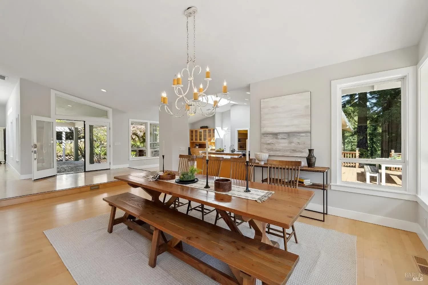 Dining room with a long table and doors to the deck
