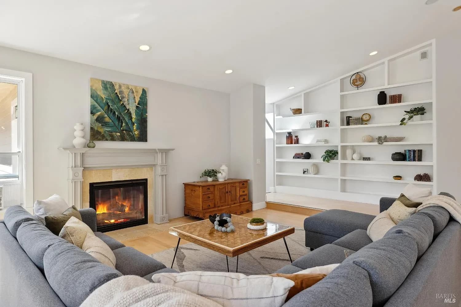 Living room seating gathered around the fireplace