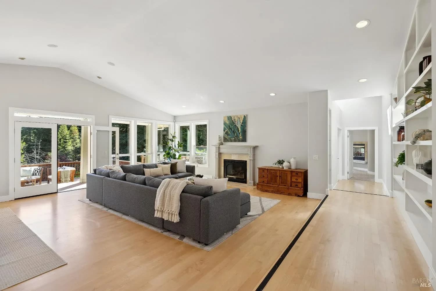 Light-filled living room with fireplace and garden views