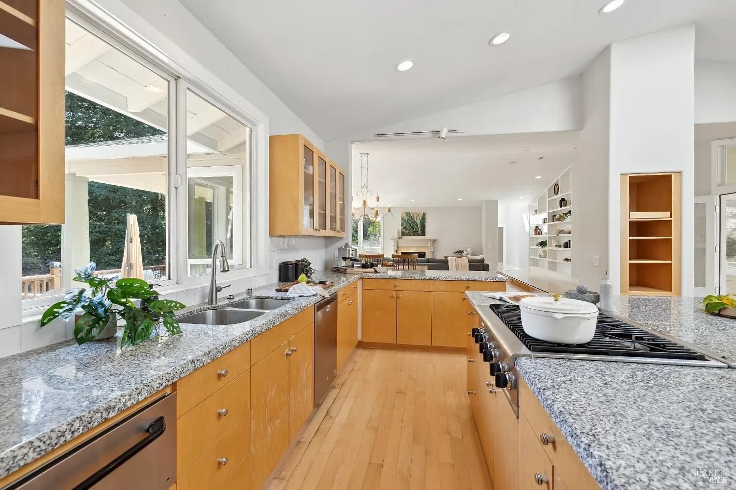 Spacious main kitchen with granite counters and wood cabinetry