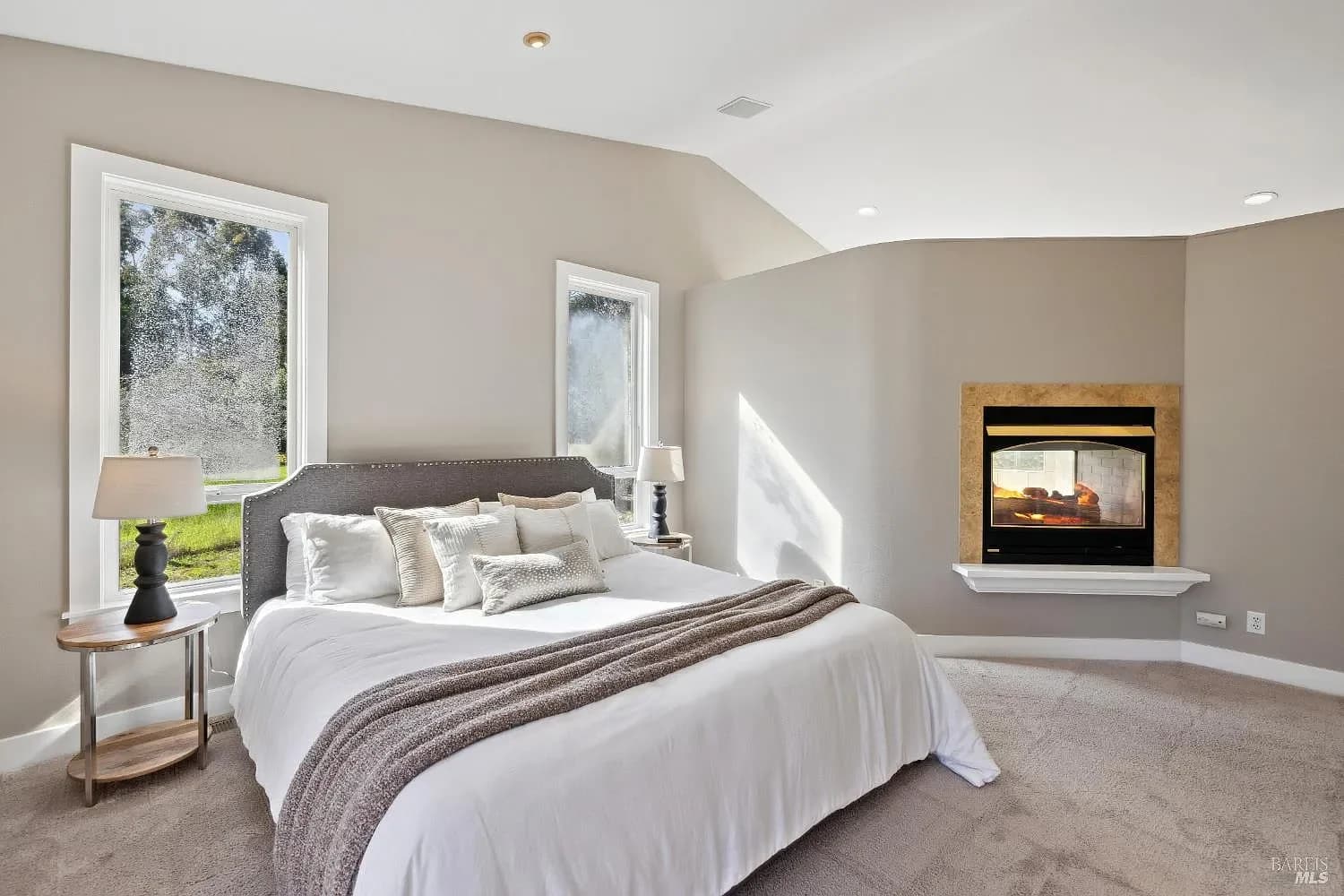 Primary bedroom with fireplace and orchard views