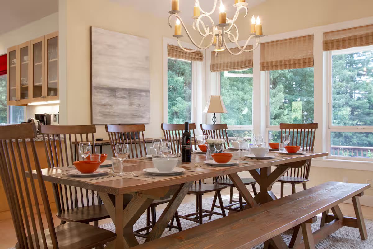 Large dining table surrounded by windows